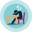 Person in chair sleeping at desk.